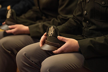 Military Students holding their hats